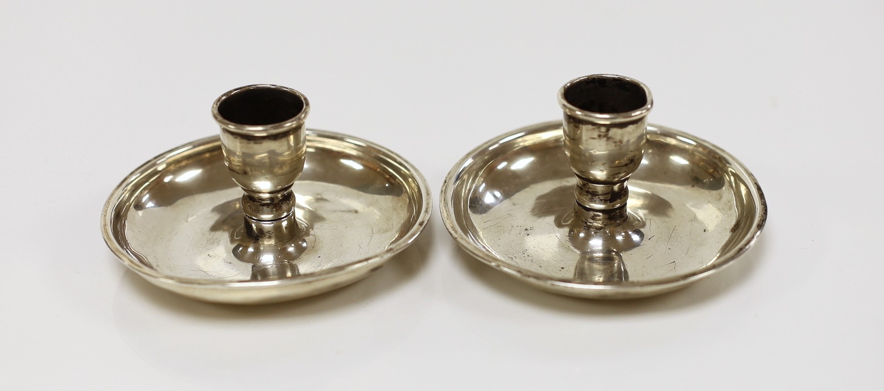 A pair of 19th century silver plated 'Brighton Bun' travelling candlesticks, diameter 85mm.